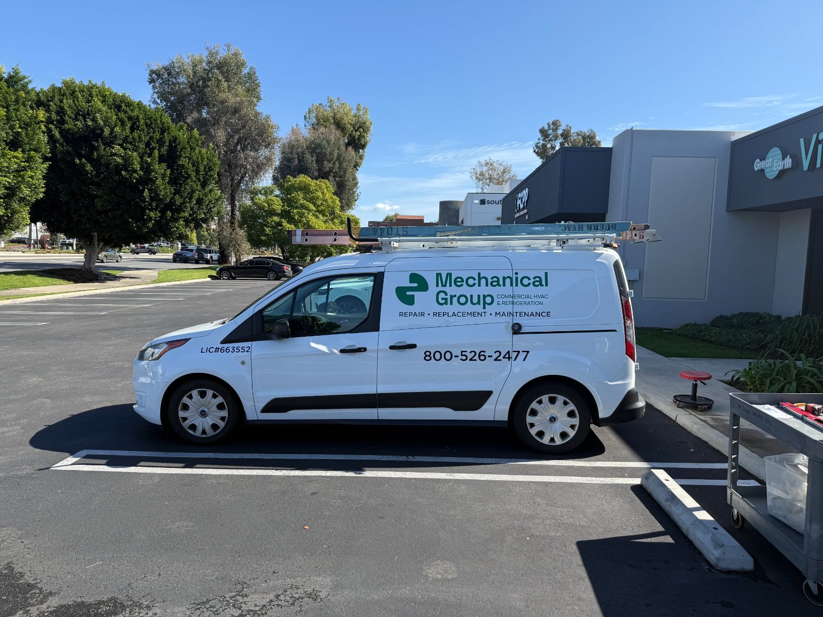 Driver side of a white Ford Transit Connect van with Mechanical Group graphics: green-and-black cut vinyl logo, 'Commercial HVAC & Refrigeration' tagline, license number and phone number, installed by Hi Sign, Brea, CA