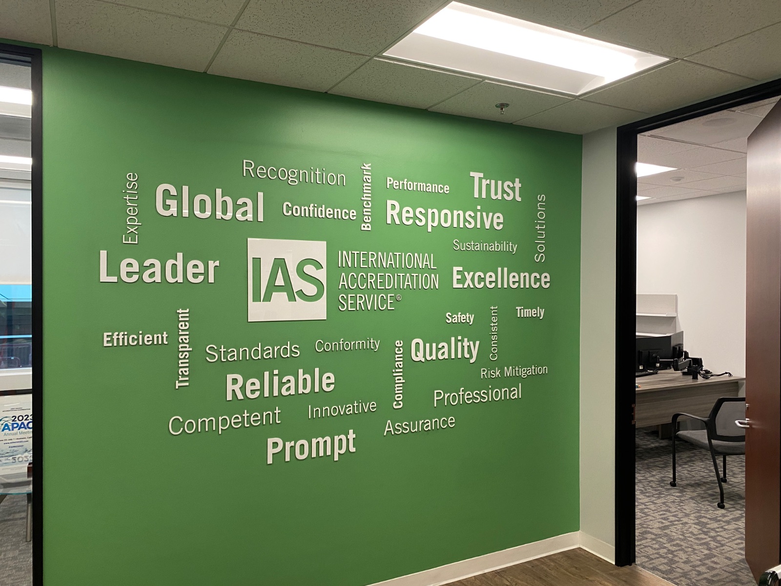 The full green word-cloud wall photographed straight on, the complete cut-vinyl layout visible corner to corner, installed by Hi Sign, Brea, CA