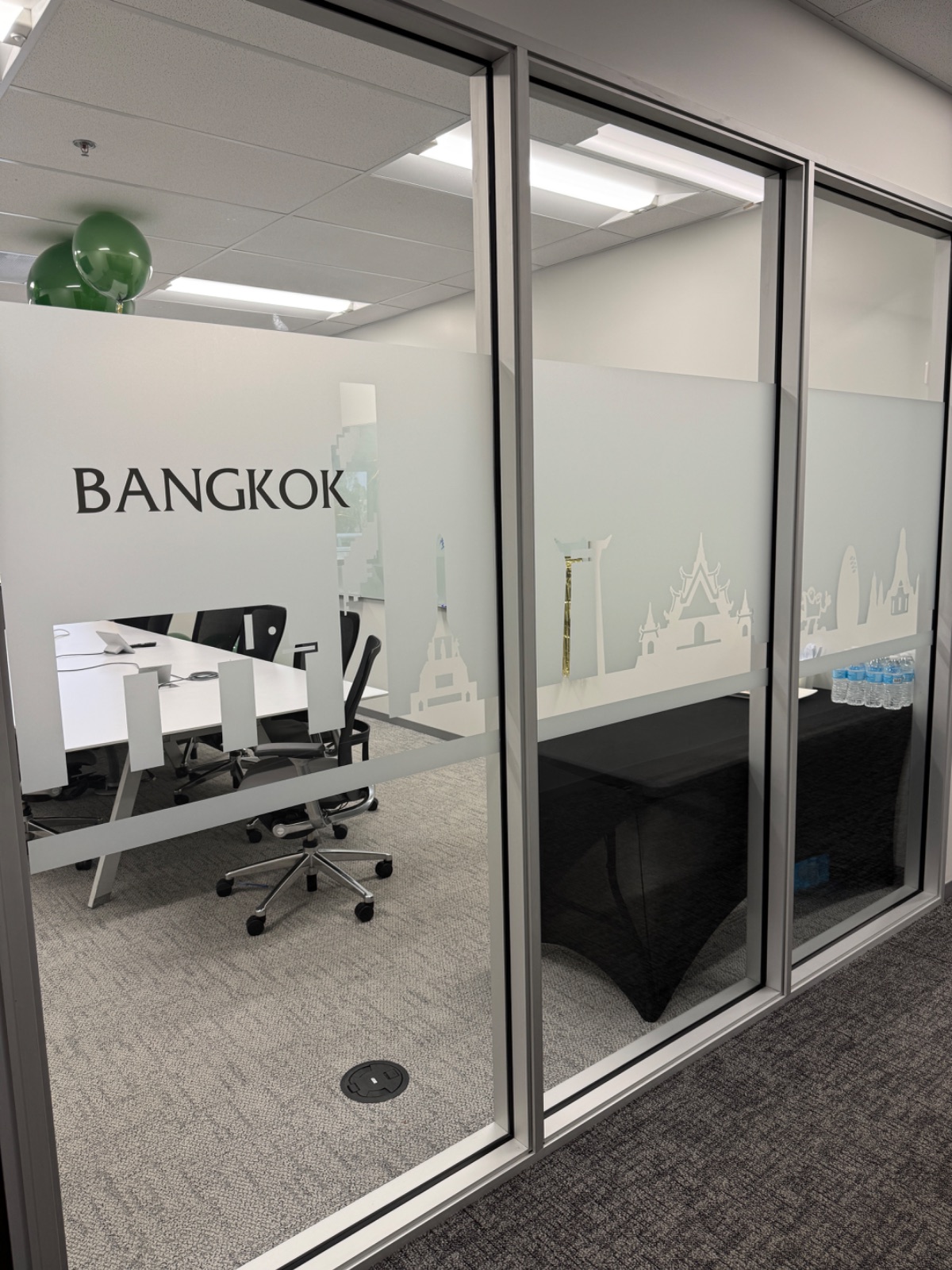 Glass-walled office room with a frosted band carrying a cut-vinyl Bangkok skyline and the room name BANGKOK, installed by Hi Sign, Brea, CA